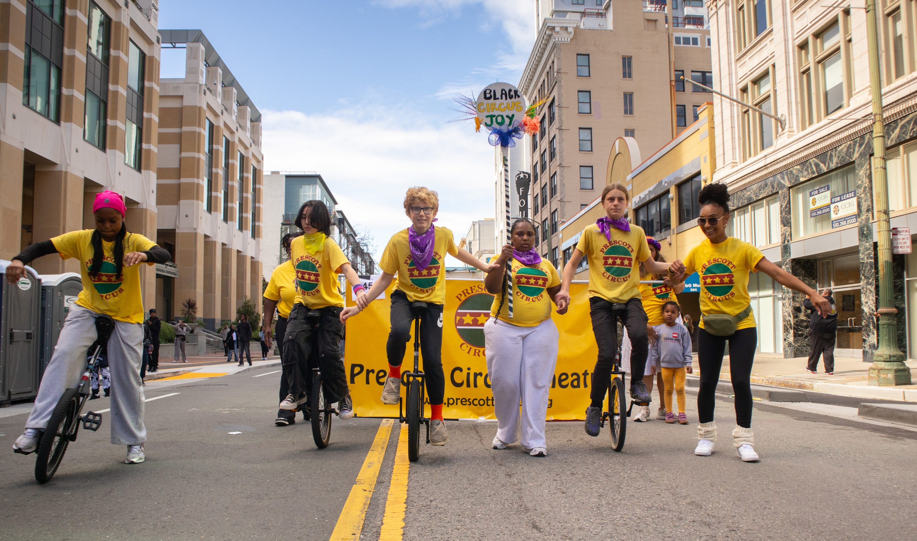 Photo credit: Tom Holub. Students on unicycles and on foot lead the Prescott Circus group for the Feb 20 Black Joy Parade